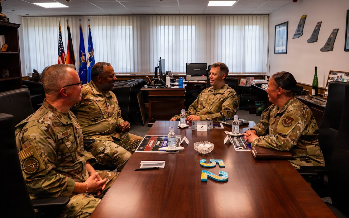 U.S. Air Force Col. Ralph Elliott, Europe-Air Forces Africa command chaplain, second from left, and U.S. Air Force Chief Master Sgt. Andrew Fraser, Air National Guard liaison to Headquarters USAFE-AFAFRICA Office of the Command Chaplain senior enlisted leader, left, meet with Col. William Lutmer, the 52nd Fighter Wing commander and Chief Master Sgt. Mary Trent, the wing’s command chief, during a visit to Spangdahlem Air Base, Germany, June 24, 2026. The officials discussed mission priorities, religious support initiatives and the role spiritual readiness play in supporting Airmen at Spangdahlem and its geographically separated units. Fraser is the  liaison to Headquarters USAFE-AFAFRICA Office of the Command Chaplain senior enlisted leader (U.S. Air Force photo by Airman 1st Class Kacie Ramos)