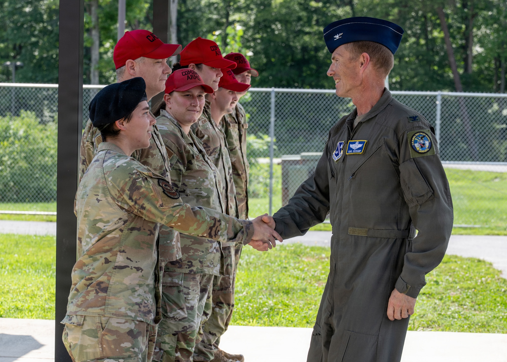 U.S. Air Force Col. Karl W. Seekamp, 316th Wing and installation commander, greets the combat arms training and maintenance team at the CATM facility during his wing immersion.
