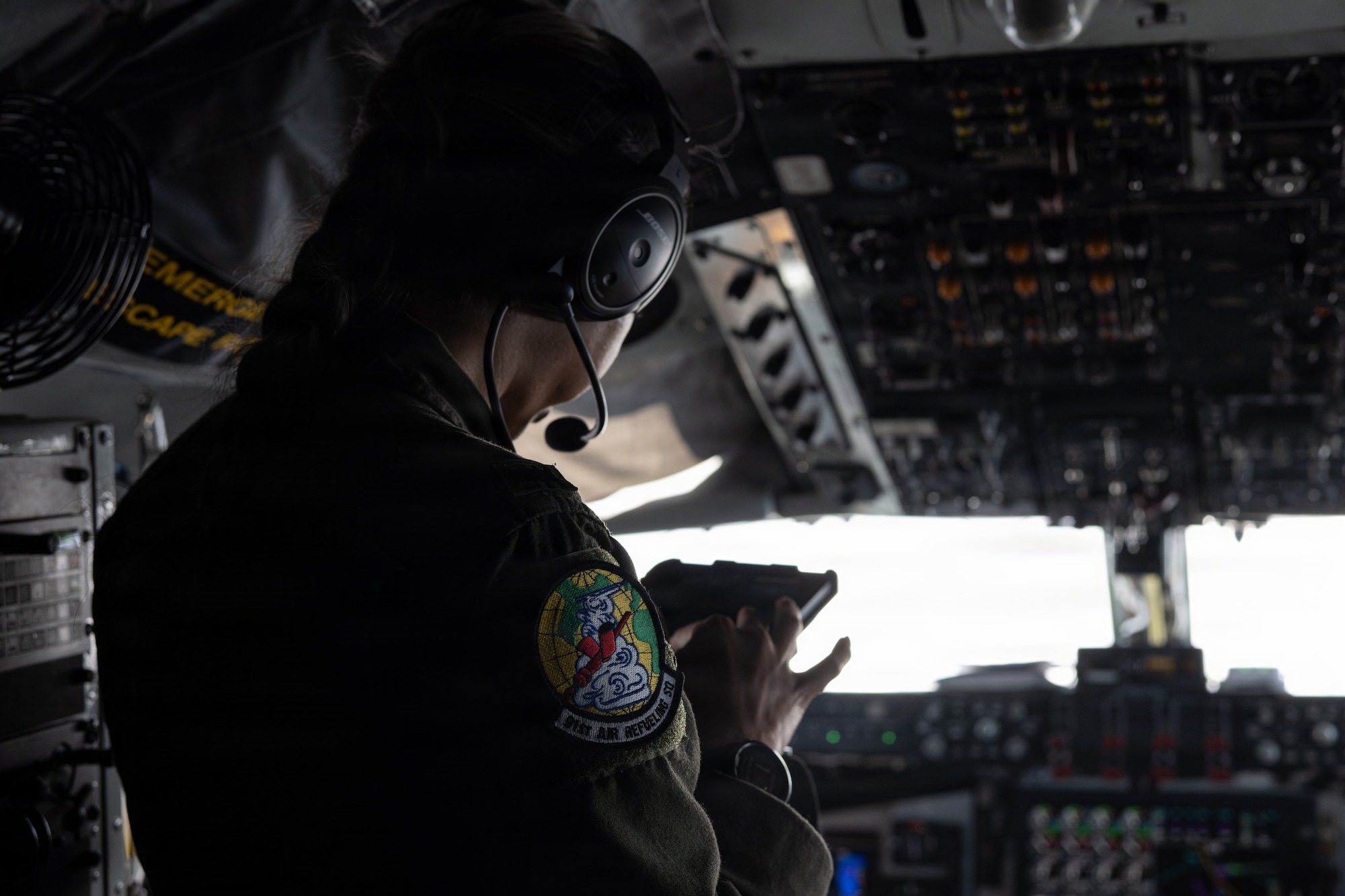 U.S. Air Force 1st Lt. Ana Gomez-Martinez, a pilot assigned to the 91st Air Refueling Squadron, monitors mission data during a training flight over the southeastern region of the United States, June 30, 2026. Aircrews continuously review mission data and strengthen the skills required to support rapid global air mobility. (U.S. Air Force photo by Airman 1st Class Helen Ly)