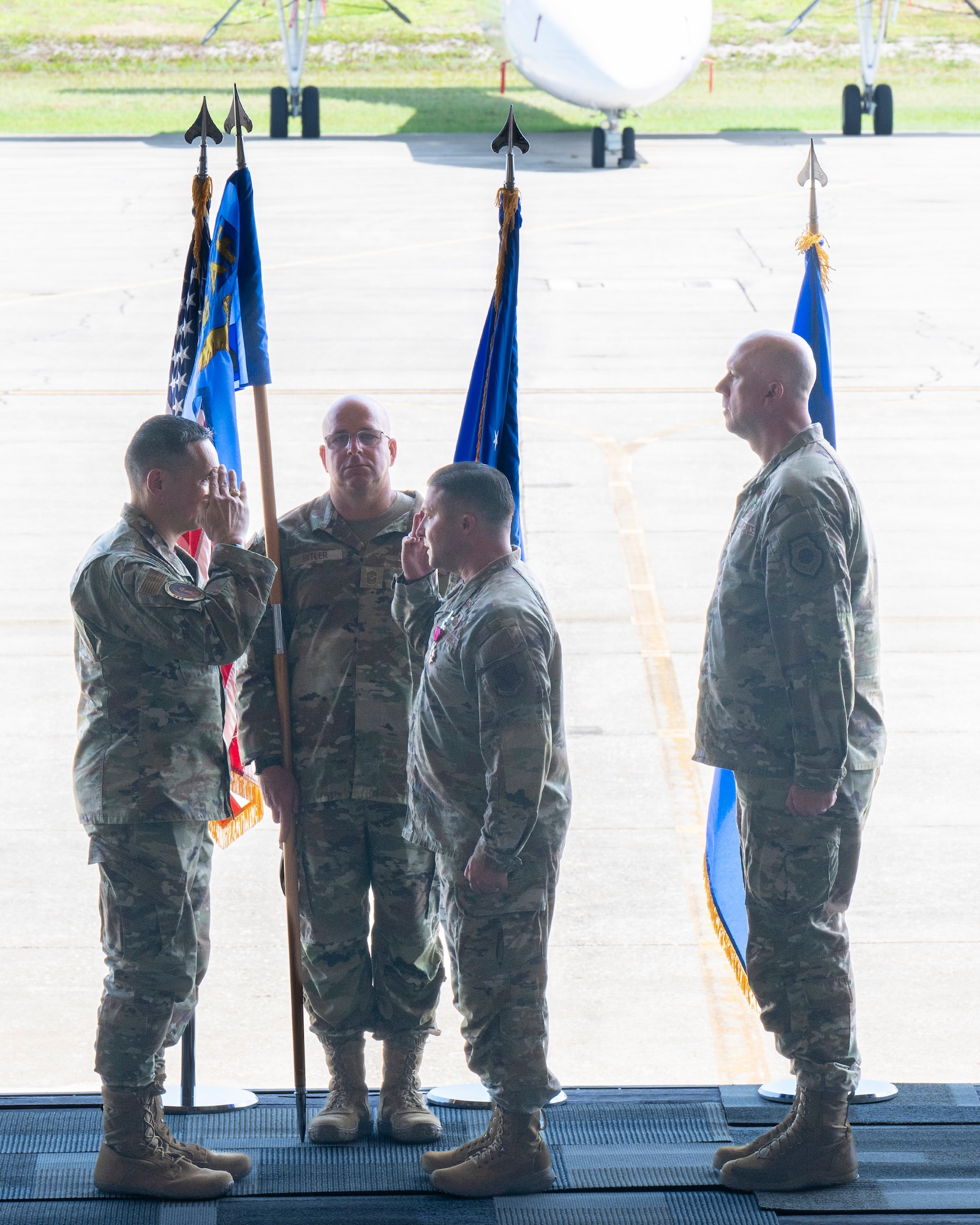Col. Creighton Mullins (center), outgoing commander of the Air Force Technical Applications Center, renders a salute to Lt. Gen. Thomas K. Hensley, (left) during a Change of Command ceremony July 24, 2026 at Patrick Space Force Base, Fla.  Also pictured are Col. Mark Brow (right), AFTAC’s new commander, and Chief Master Sgt. Brandon Bitler, guidon bearer and AFTAC’s Command Chief. (U.S. Air Force photo by Matthew S. Jurgens)