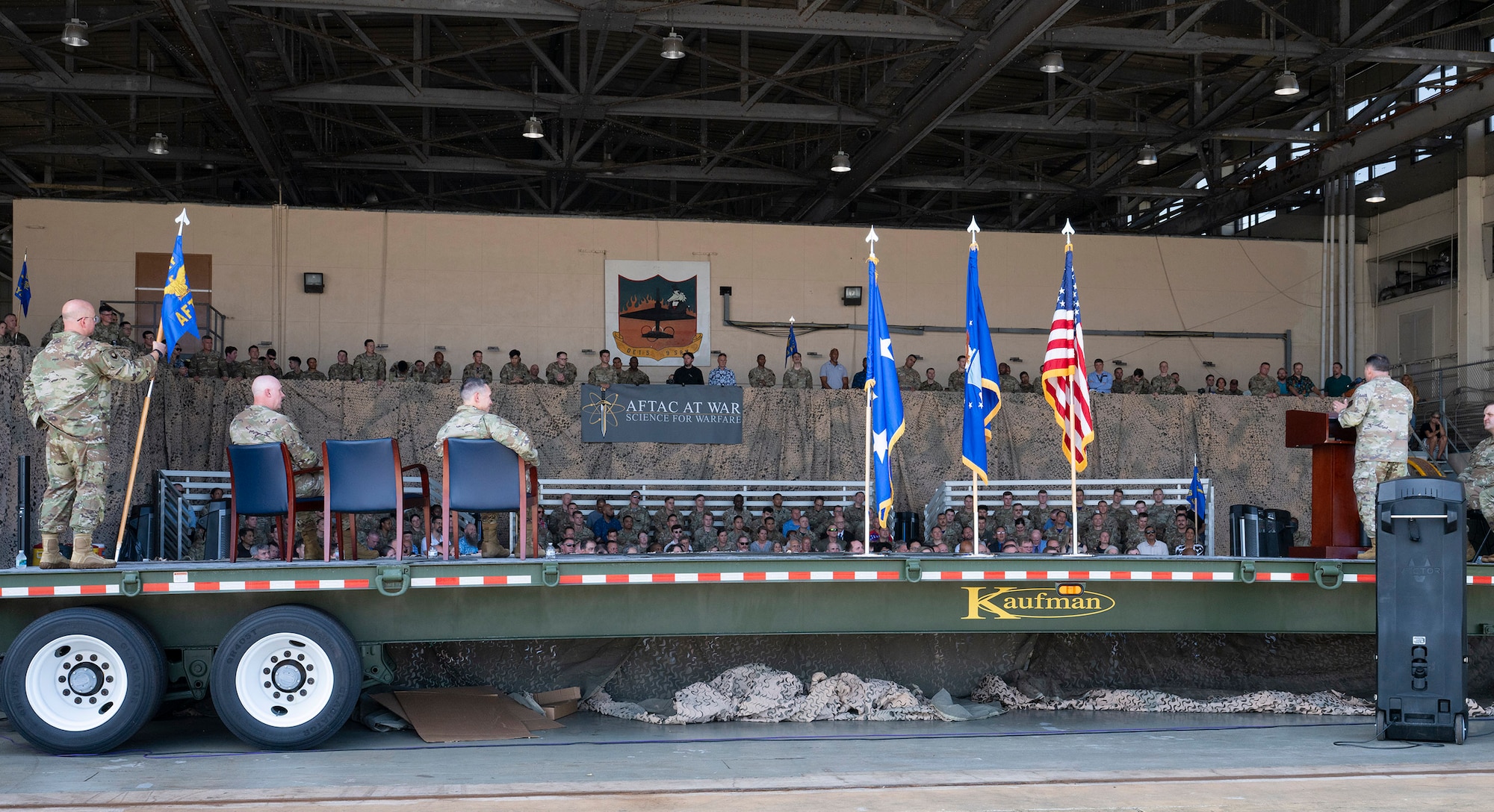 The Air Force Technical Applications Center, the Department of War’s sole nuclear surveillance monitoring organization, held a Change of Command ceremony July 24, 2026, where Col. Creighton Mullins (at podium) relinquished command to Col. Mark Brow, (seated far left), with Lt. Gen. Thomas K. Hensley, 16th Air Force Commander (Air Forces Cyber) as the presiding officer.  The ceremony was held in the U.S. State Department’s hangar at Patrick Space Force Base, Fla. (U.S. Air Force photo by Matthew S. Jurgens)