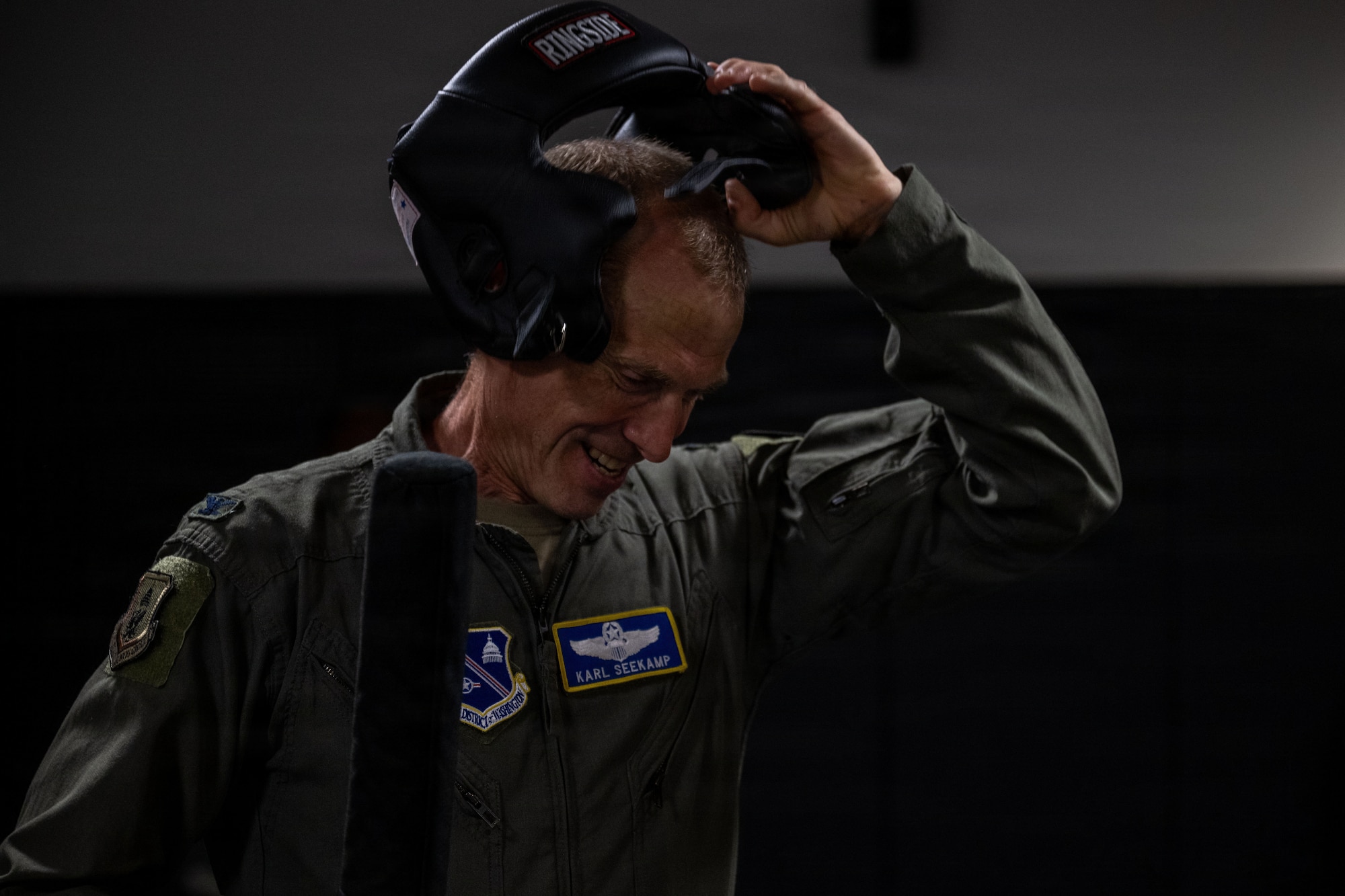 U.S. Air Force Col. Karl W. Seekamp, 316th Wing and installation commander, takes off protective headgear after participating in the redman training exercise.