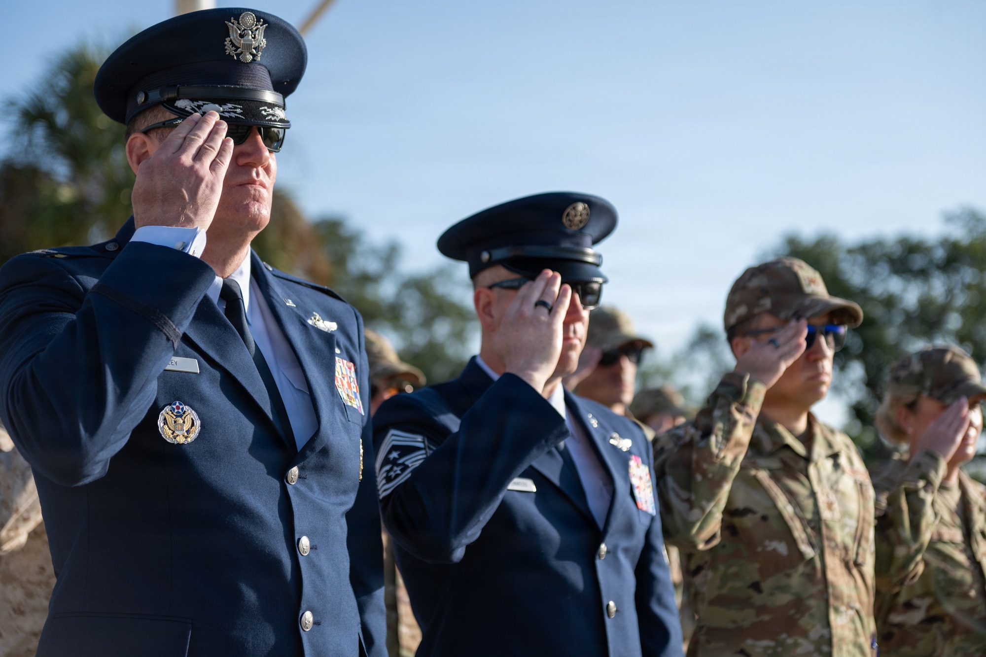 U.S Air Force Col. Kevin Eley, 6th Air Refueling Wing commander, left, and Chief Master Sgt. Christopher Ottenwess, 6th ARW command chief, renders a salute during military honors played at a base honor guard induction ceremony at MacDill Air Force Base, Florida, July 22, 2026. Eley and other members of 6th ARW leadership attended the ceremony to congratulate the installation’s newest ceremonial guardsmen on their completion of training. (U.S. Air Force photo by Senior Airman Derrick Bole)