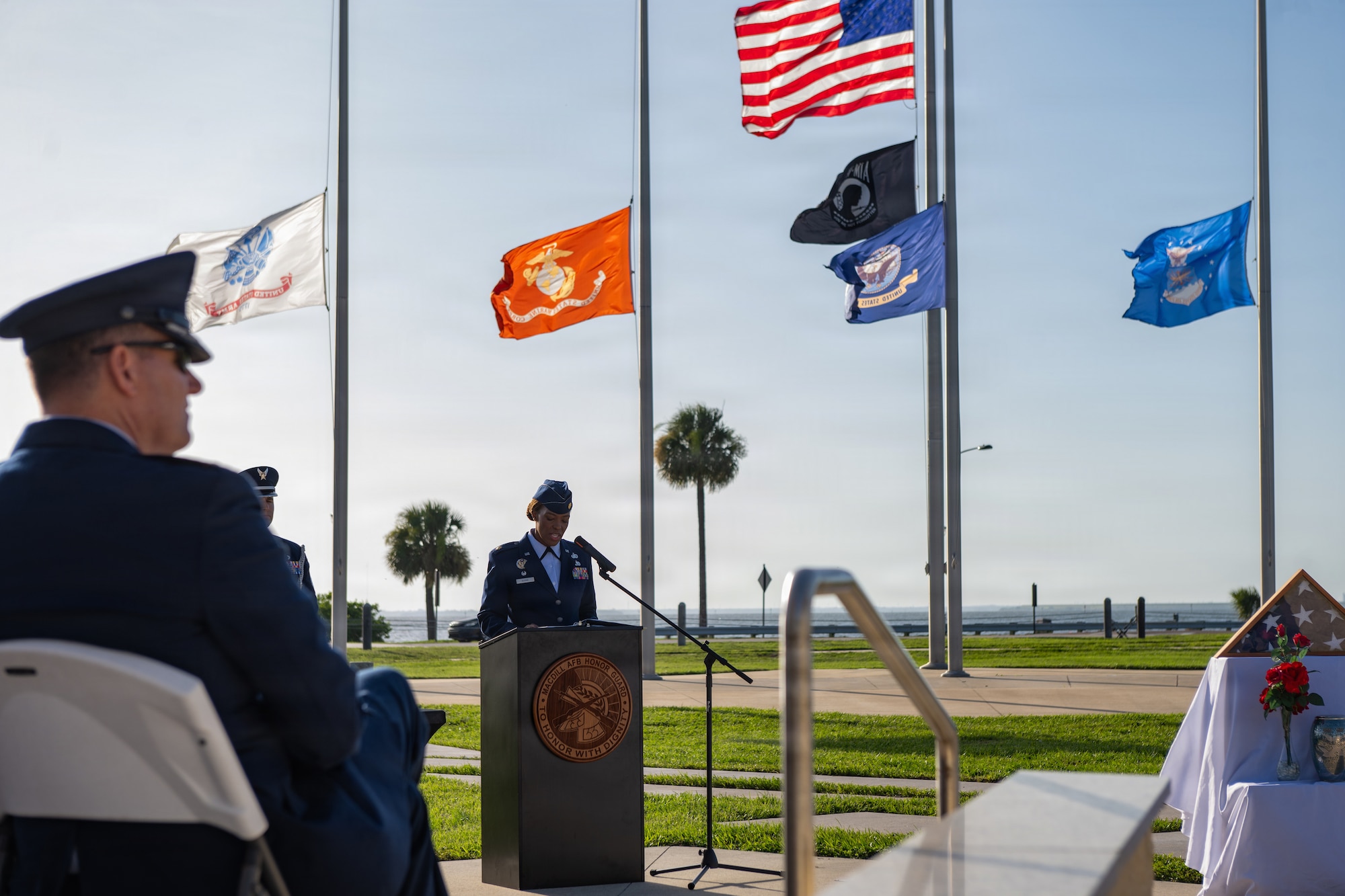 U.S. Air Force Maj. Kenda Gusme, 6th Force Support Squadron commander, addresses a crowd of attendees during a base honor guard induction ceremony at MacDill Air Force Base, Florida, July 22, 2026. Gusme served both in the USAF Honor Guard and the base honor guard at Spangdalem Air Force Base, Germany, and impressed upon the new guardsmen the importance of their position. (U.S. Air Force photo by Senior Airman Derrick Bole)