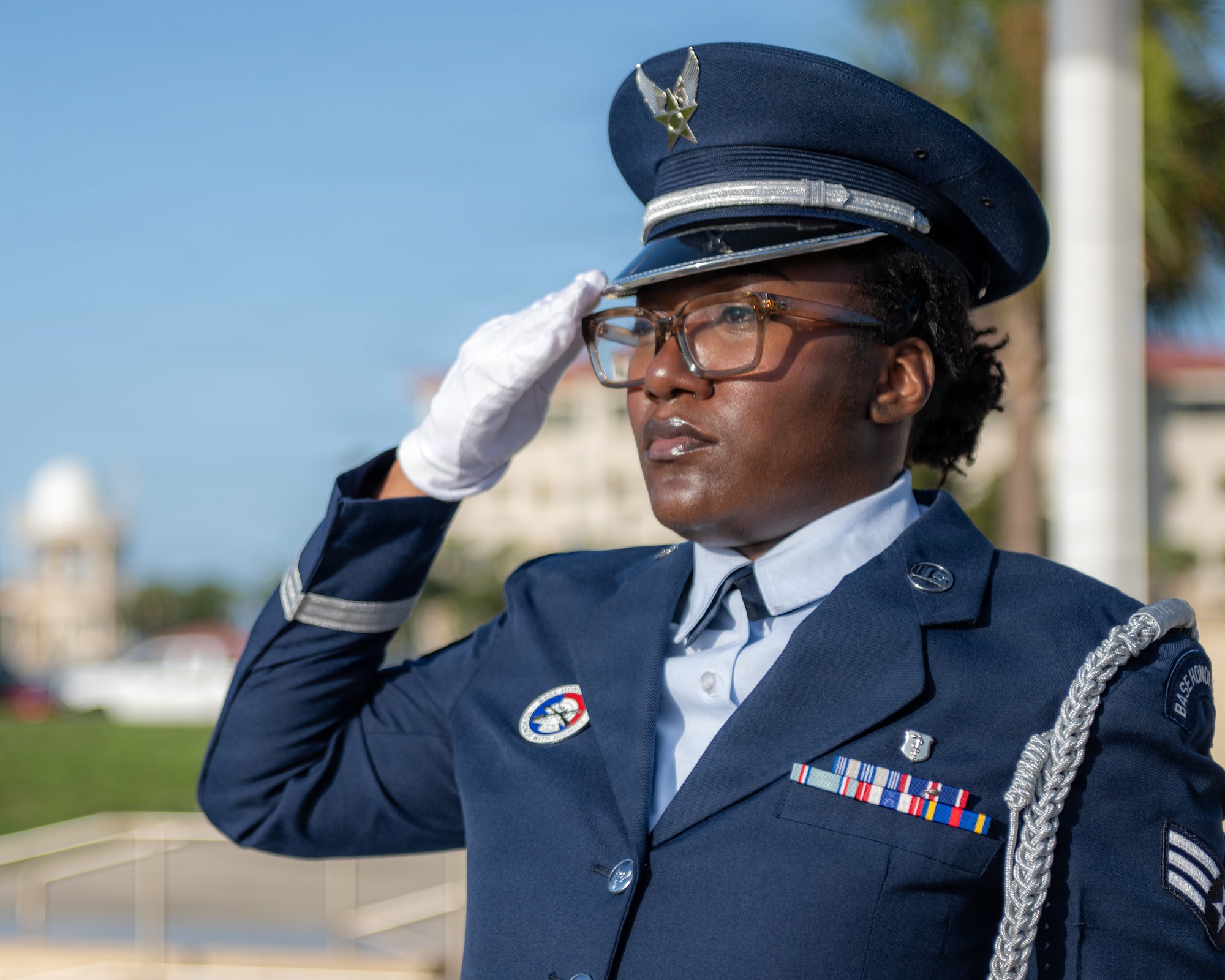 U.S. Air Force Senior Airman Xitlanie Lockhart, 6th Force Support Squadron ceremonial guardsman, renders a salute during military honors at a base honor guard induction ceremony at MacDill Air Force Base, Florida, July 22, 2026. Lockhart was among ten other Airmen to complete training and be awarded the title of ceremonial guardsman after two weeks of training. (U.S. Air Force photo by Senior Airman Derrick Bole)