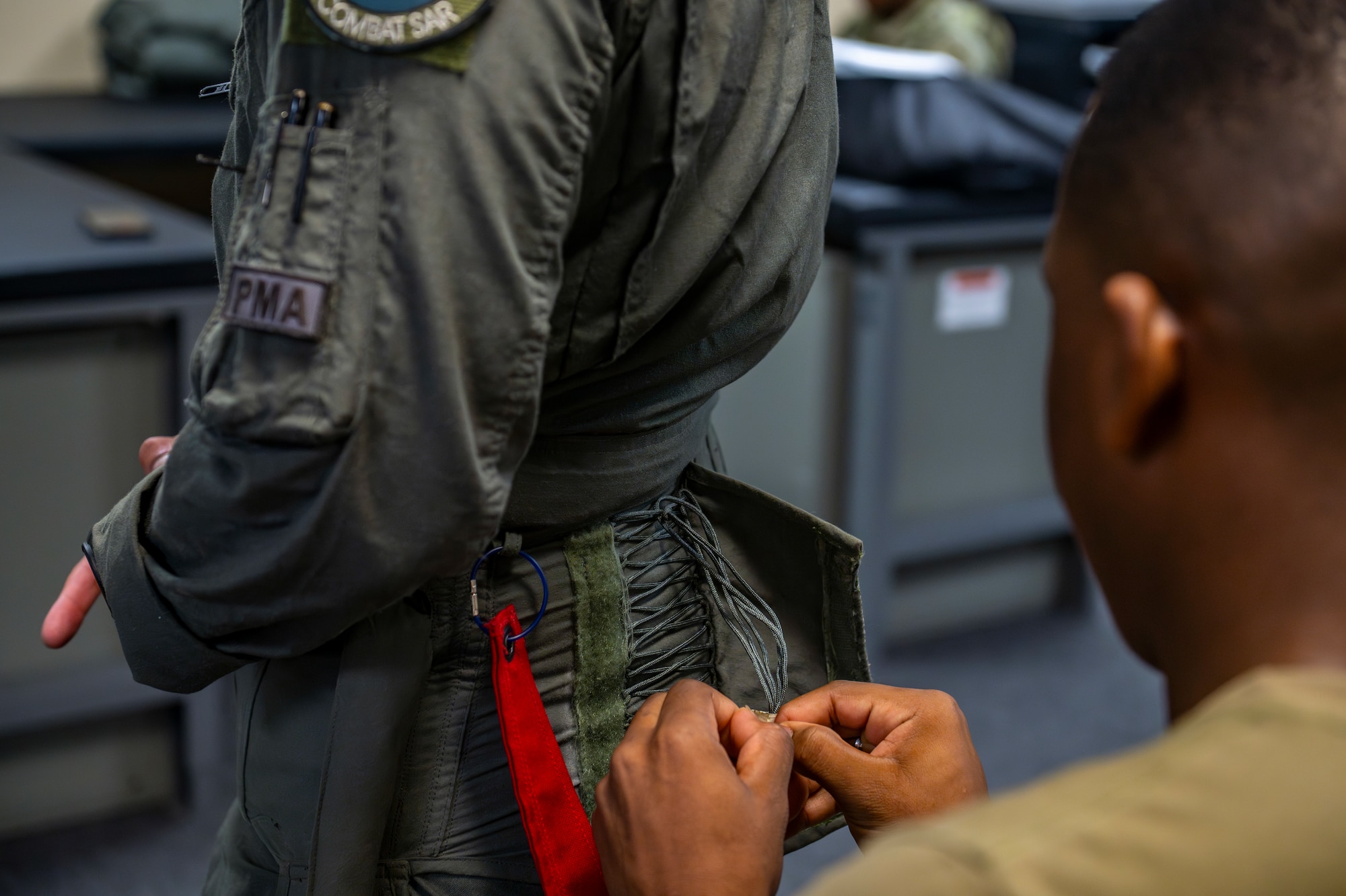 Airman tying flight suit