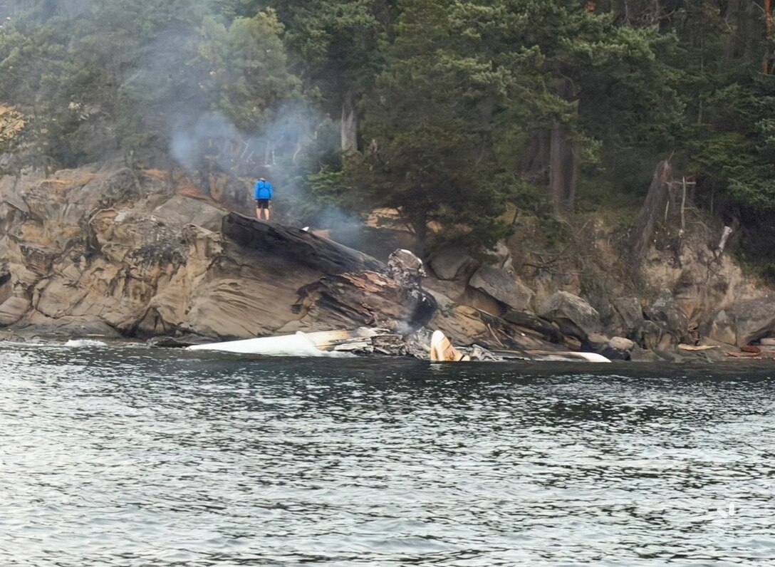 Debris sits against the rocks of Sucia Island, Washington, after a seaplane conducted an emergency landing