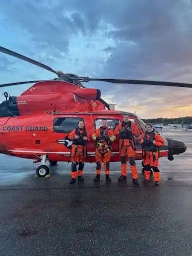 A MH-65 Dolphin aircrew from Air Station Port Angeles stands for a photo after a search and rescue case