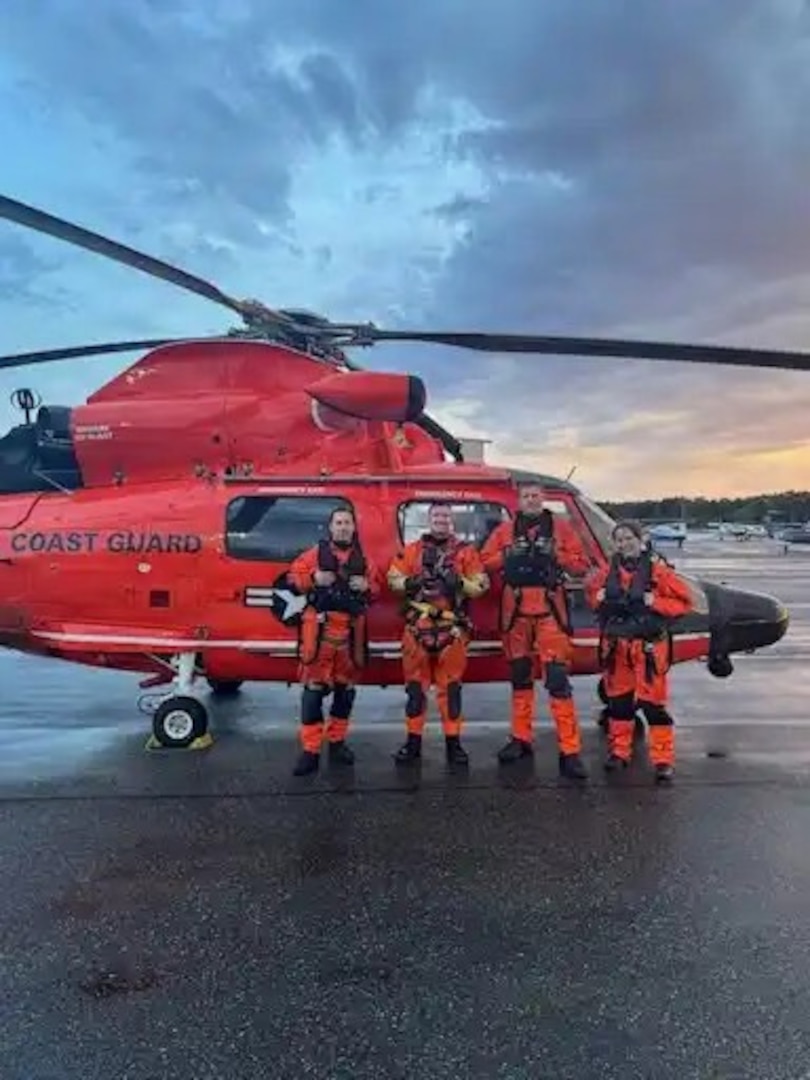 A MH-65 Dolphin aircrew from Air Station Port Angeles stands for a photo after a search and rescue case