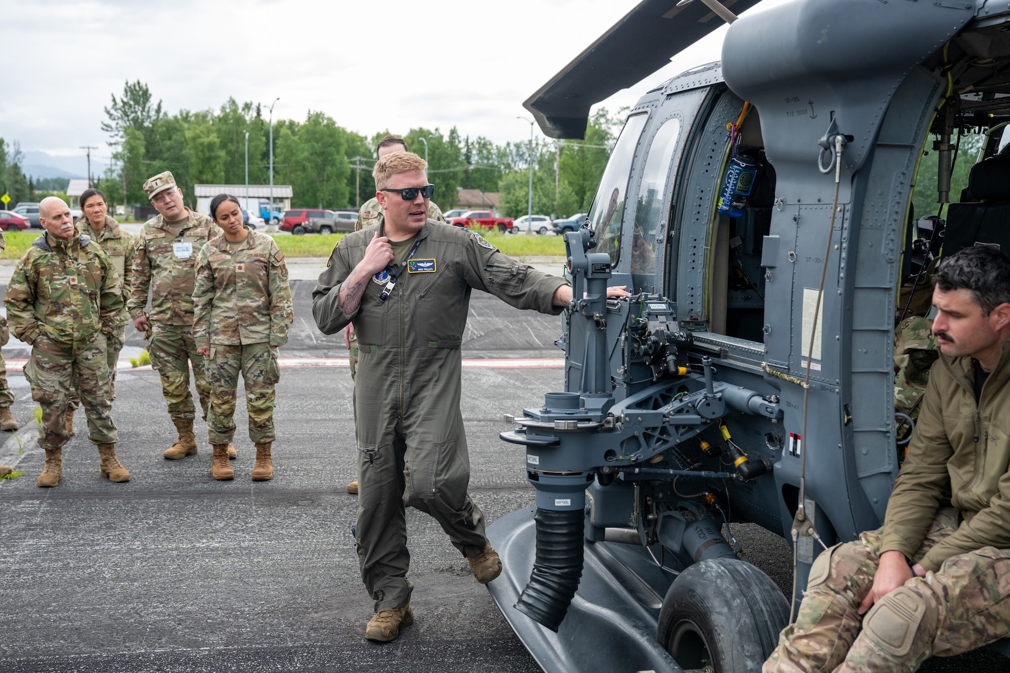 U.S. Air Force Capt. Aaron Phillips, 176th Wing Alaska Air National Guard instructor pilot and weapons officer, informs Airmen assigned to the 673d Medical Group on the weapons capability of the HH-60W Jolly Green II at Joint Base Elmendorf-Richardson, Alaska, July 15, 2026.