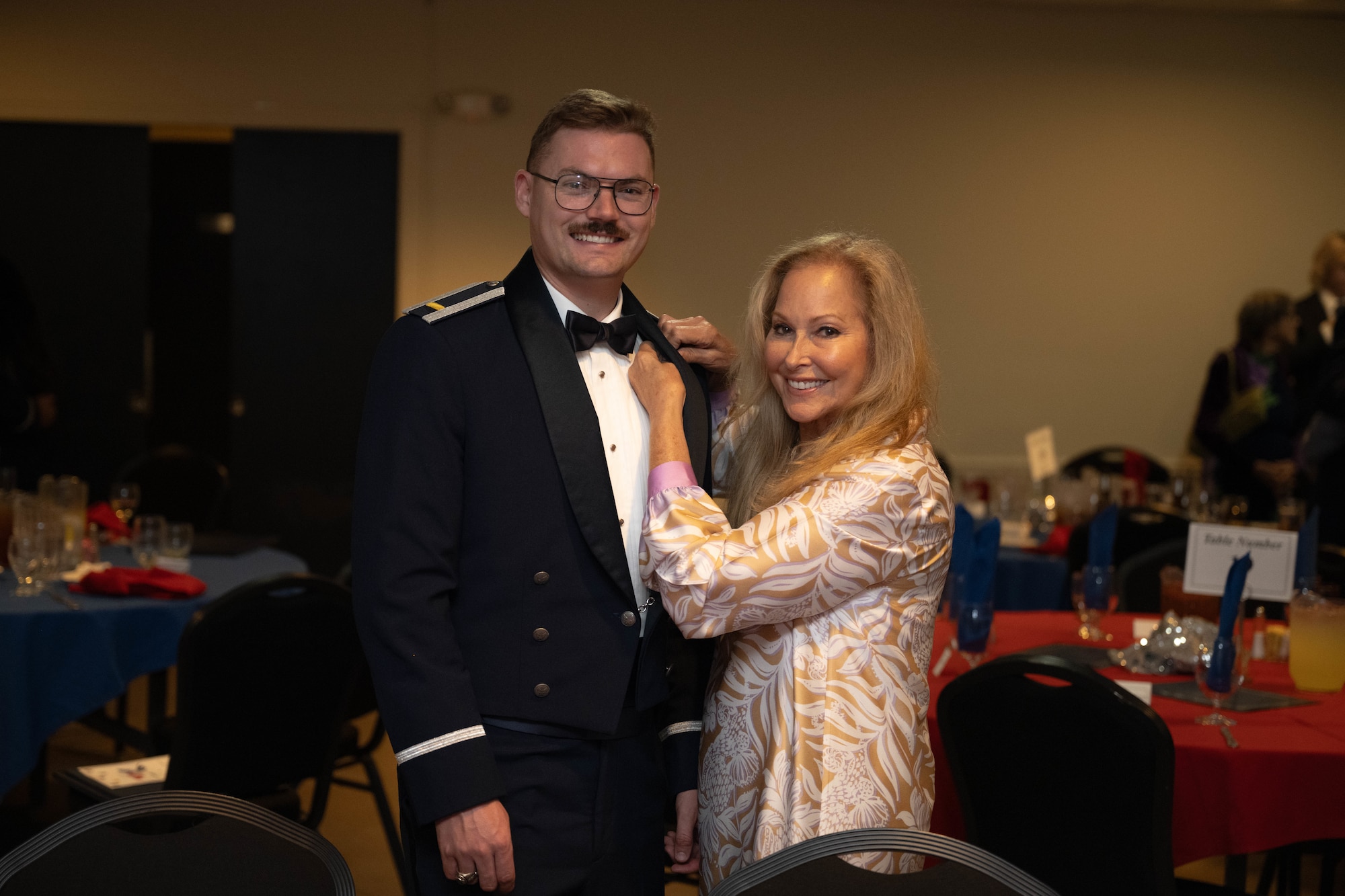 U.S. Air Force 2nd Lt. John Crosby, 47th Student Squadron student pilot, left, receives their silver wings by a loved one during the graduation ceremony of Class 26-14 and 26-12 AU at Laughlin Air Force Base, Texas, July 23, 2026. Thirty Air Force officers were awarded silver wings, officially earning the aeronautical rating of pilot. (U.S. Air Force photo by Airman 1st Class Darryl Keith)