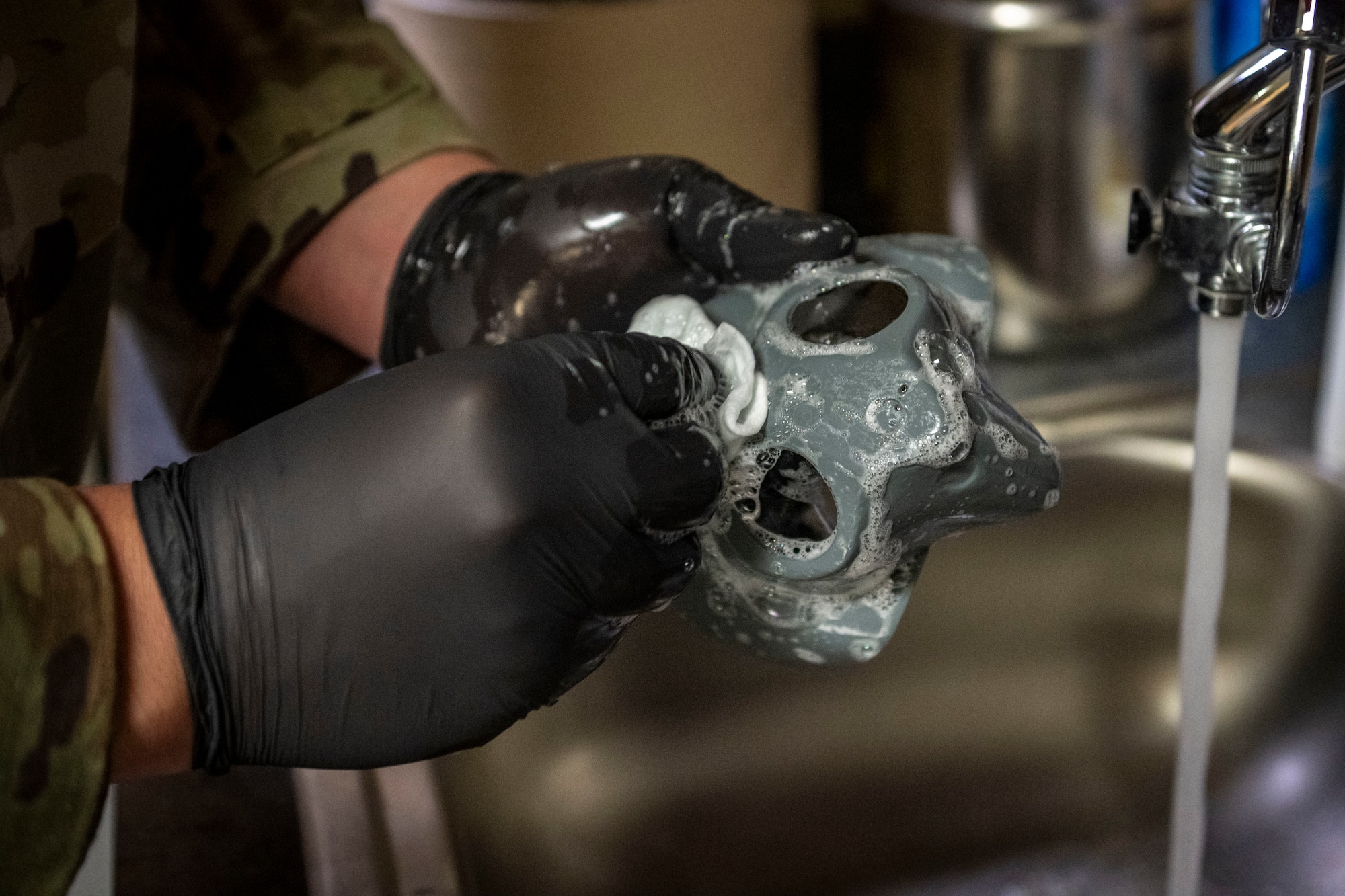 Airman cleaning gear