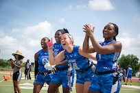 U.S. Air Force athletes cheer on their teammates from the sidlines during the Armed Forces Flag Football Championships at Cougar Stadium on Fort Sam Houston, Texas, July 25, 2026. Service members competed for championship honors while representing their respective services. Armed Forces sports bring together service members from the Army, Marine Corps, Navy (with Coast Guard athletes), and Air Force (with Space Force athletes) to compete at the national level. Armed Forces Sports pormotes physicl fitness, provides competitive opportunities for military athletes at national and international levels, supports recruitment and retention efforts, and strengthens partnerships through sports diplomacy. (U.S. Air Force photo by Staff Sgt. Jonathan Anderson)