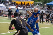 U.S. Air Force Staff SGt. Haydn Wall, stationed at Joint Base Pearl Harbor-Hickan, Hawaii, dodges a defender during the Armed Forces Flag Football Championships at Cougar Stadium on Fort Sam Houston, Texas, July 25, 2026. Service members competed for championship honors while representing their respective services. Armed Forces sports bring together service members from the Army, Marine Corps, Navy (with Coast Guard athletes), and Air Force (with Space Force athletes) to compete at the national level. Armed Forces Sports pormotes physicl fitness, provides competitive opportunities for military athletes at national and international levels, supports recruitment and retention efforts, and strengthens partnerships through sports diplomacy. (U.S. Air Force photo by Staff Sgt. Jonathan Anderson)