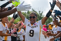 U.S. Army 1st Lt. Ky'achia Carey, stationed at Fort Bragg, North Carolina, high fives teammates during the Armed Forces Flag Football Championships at Cougar Stadium on Fort Sam Houston, Texas, July 25, 2026. Service members competed for championship honors while representing their respective services. Armed Forces sports bring together service members from the Army, Marine Corps, Navy (with Coast Guard athletes), and Air Force (with Space Force athletes) to compete at the national level. Armed Forces Sports pormotes physicl fitness, provides competitive opportunities for military athletes at national and international levels, supports recruitment and retention efforts, and strengthens partnerships through sports diplomacy. (U.S. Air Force photo by Staff Sgt. Jonathan Anderson)