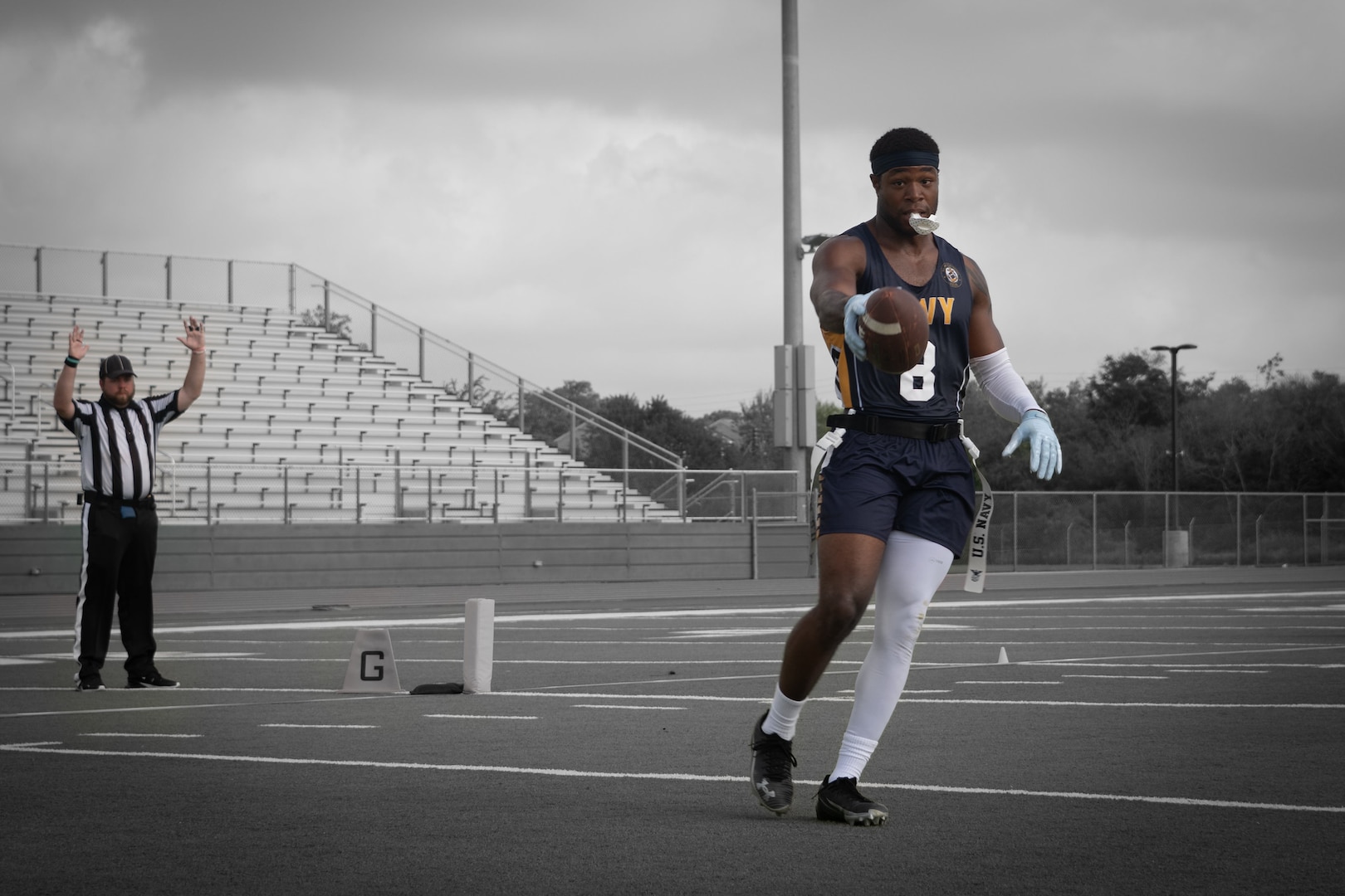 U.S. Navy Petty Officer 2nd Class Marquiste Jackson, stationed at Naval Air Station Jacksonville, Florida, scores a touchdown during the Armed Forces Flag Football Championships at Cougar Stadium on Fort Sam Houston, Texas, July 25, 2026. Service members competed for championship honors while representing their respective services. Armed Forces sports bring together service members from the Army, Marine Corps, Navy (with Coast Guard athletes), and Air Force (with Space Force athletes) to compete at the national level. Armed Forces Sports pormotes physicl fitness, provides competitive opportunities for military athletes at national and international levels, supports recruitment and retention efforts, and strengthens partnerships through sports diplomacy. (U.S. Marine Corps photo by Cpl. Diana Salgado)