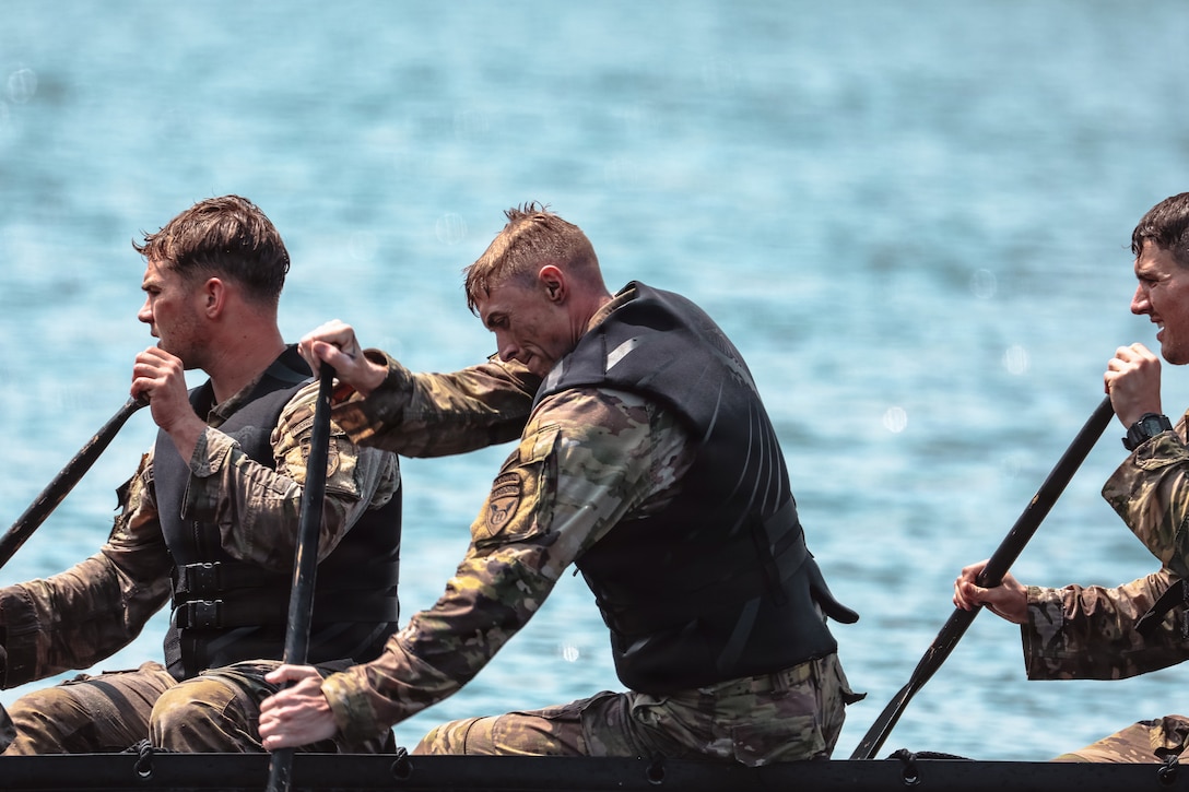 U.S. Army Staff Sgt. Chad Hale, left, assigned to the 11th Airborne Division, paddles a zodiac boat during the U.S. Army Pacific Best Squad Competition at Joint Base Lewis-McChord, Wash., July 23, 2026. (U.S. Army photo by Sgt. Taylor Zacherl)