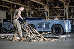 U.S. Air Force Senior Airman Kyle Graff, 35th Logistics Readiness Squadron air transportation function journeyman, prepares to secure cargo in support of Red Flag-Alaska 26-3.