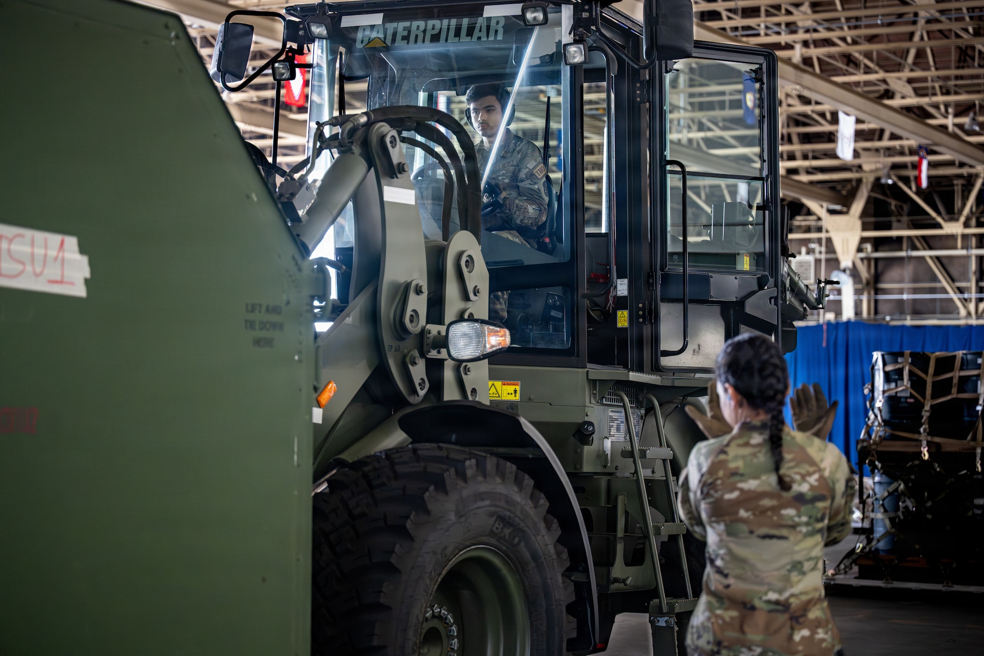 U.S. Air Force Senior Airman Destiny Ross, 35th Logistics Readiness Squadron inbound cargo technician, right, and Airman 1st Class Alexavier Villanueva, 35th LRS outbound cargo technician, prepare cargo for inspection in support of Red Flag-Alaska 26-3.