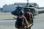 Japan Ground Self-Defense Force members with 13th Brigade, Middle Army, carry a stretcher to a JGSDF UH-1Y helicopter during Exercise Nankai Rescue at Marine Corps Air Station Iwakuni, Japan, Jan. 16, 2025.