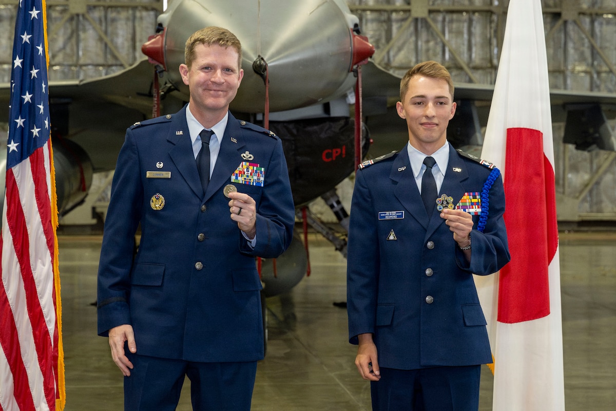 U.S. Civil Air Patrol Cadet Col. Cayne Redmond, right, and U.S. Air Force Col. John Connor, 35th Mission Support Group commander, pose for a photograph holding challenge coins during Redmond’s General Carl A. Spaatz Award ceremony at Misawa Air Base, Japan, May 27, 2026.