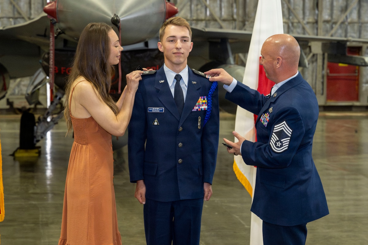 U.S. Civil Air Patrol Cadet Col. Cayne Redmond, center, has the rank of cadet colonel pinned by his parents during his General Carl A. Spaatz Award ceremony at Misawa Air Base, Japan,