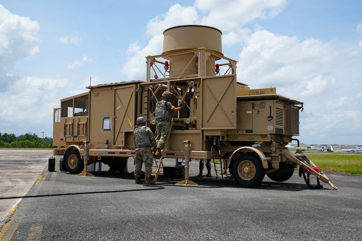 Tech. Sgt. Kevin Butler, left, and Staff Sgt. Dan Alejandro Bernardo, 53rd Combat Airfield Operations Squadron Radar Airfield and Weather Systems technicians, sustain equipment on the Deployable Tactical Air Navigation system at Robins Air Force Base, Georgia, July 21, 2026.