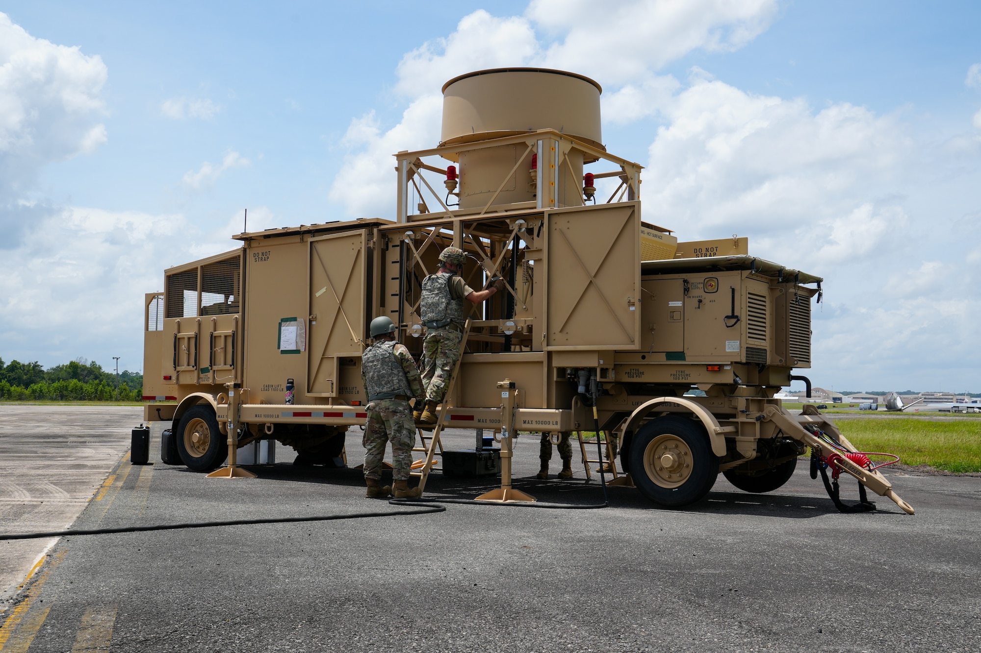 Tech. Sgt. Kevin Butler, left, and Staff Sgt. Dan Alejandro Bernardo, 53rd Combat Airfield Operations Squadron Radar Airfield and Weather Systems technicians, sustain equipment on the Deployable Tactical Air Navigation system at Robins Air Force Base, Georgia, July 21, 2026.