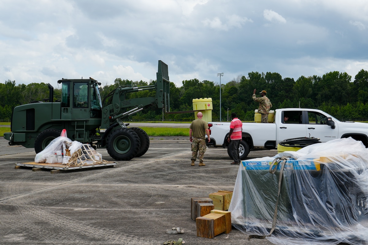 Tech. Sgt. Tyler Muldowney, left, and Staff Sgt. Muhammad Garba, right, 53rd Combat Airfield Operations Squadron Radar Airfield and Weather Systems technicians, direct a vehicle to load fuel to transport to another radar site set up on the other side of the airfield at Robins Air Force Base, Georgia, July 21, 2026.