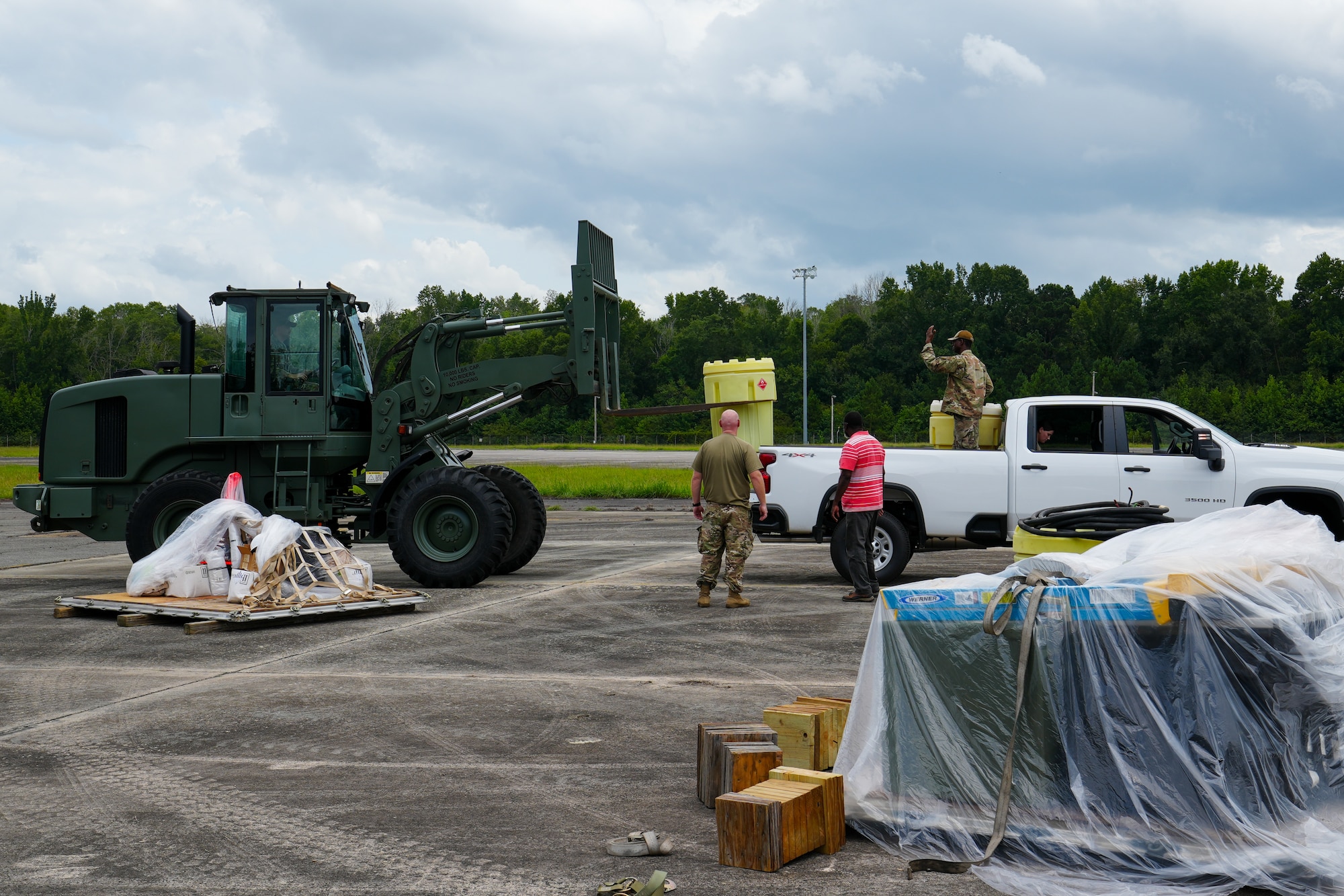 Tech. Sgt. Tyler Muldowney, left, and Staff Sgt. Muhammad Garba, right, 53rd Combat Airfield Operations Squadron Radar Airfield and Weather Systems technicians, direct a vehicle to load fuel to transport to another radar site set up on the other side of the airfield at Robins Air Force Base, Georgia, July 21, 2026.