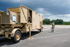 Master Sgt. Kristian Penafiel, 53rd Combat Airfield Operations Squadron Radar Airfield and Weather Systems technician, simulates a spectator taking photos for social media during a certifying event at Robins Air Force Base, Georgia, July 21, 2026.