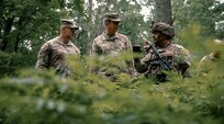 From left, Lt. Gen. Jonathan M. Stubbs, director of the Army National Guard, and Col. Jonathan M. Stewart, assistant adjutant general for Army for the Ohio National Guard, listens to a brief from Command Sgt. Maj. Matthew Strausbaugh, 1st Battalion, 148th Infantry Regiment command sergeant major, during a visit, as part of Combat Readiness Exercise, or CRX, 26-01 at Camp Grayling Joint Maneuver Training Center in Grayling, Michigan, July 21, 2026.