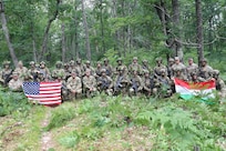 Lt. Gen. Jonathan Stubbs, director of the Army National Guard, and Command Sgt. Maj. Brian Kendrick, command sergeant major of the Army National Guard, pose with U.S. and Hungarian service members during Combat Readiness Exercise 26-01 at Camp Grayling Joint Maneuver Training Center, Michigan, July 21, 2026.