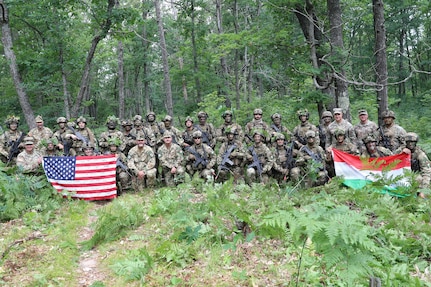 Lt. Gen. Jonathan Stubbs, director of the Army National Guard, and Command Sgt. Maj. Brian Kendrick, command sergeant major of the Army National Guard, pose with U.S. and Hungarian service members during Combat Readiness Exercise 26-01 at Camp Grayling Joint Maneuver Training Center, Michigan, July 21, 2026.