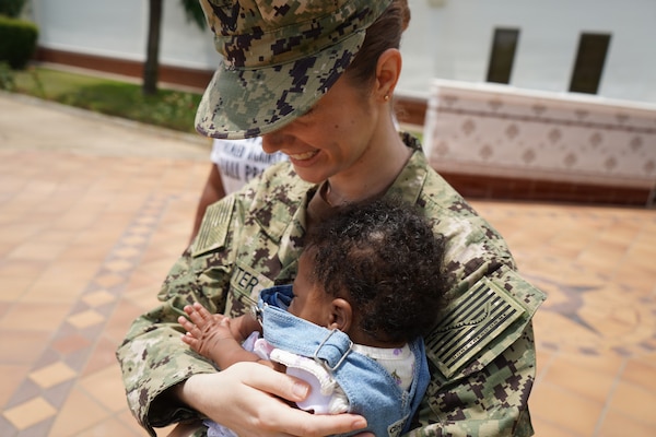 Lt. Kathleen Carter, a labor and delivery nurse working in the multiservice ward at U.S. Naval Hospital Rota, holds baby Keilah during a reunion in Rota, Spain, June 1, 2026. Carter delivered Keilah inside the family’s vehicle in the hospital parking lot after the mother arrived in active labor. Keilah was born healthy. (U.S. Navy photo by Lt. Cmdr. Alicia Sacks)