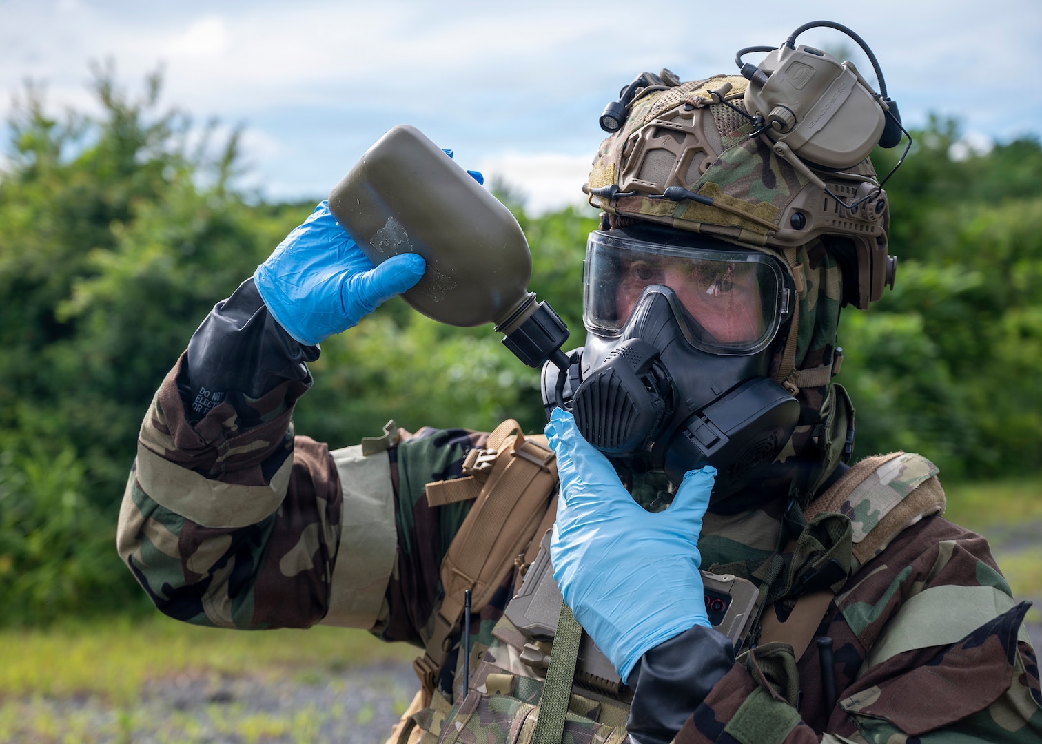 U.S. Air Force Master Sgt. Timothy Hughes, an emergency management superintendent assigned to the 163rd Civil Engineer Squadron, California Air National Guard, drinks from his canteen while wearing Mission-Oriented Protective Posture gear during Exercise Serow Samurai at Misawa Air Base, Japan, July 20, 2026.