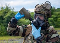 U.S. Air Force Master Sgt. Timothy Hughes, an emergency management superintendent assigned to the 163rd Civil Engineer Squadron, California Air National Guard, drinks from his canteen while wearing Mission-Oriented Protective Posture gear during Exercise Serow Samurai at Misawa Air Base, Japan, July 20, 2026.