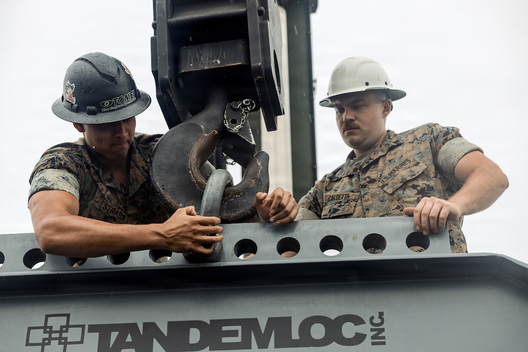 U.S. Marine Corps Jose Estrada, left, a heavy equipment operator with Marine Wing Support Squadron (MWSS) 472, Marine Aircraft Group 49, and Cpl. Addison Calsetta, an engineer equipment operator, with MWSS-472, 4th MAW, both operate a crane during Crash Damaged or Disabled Aircraft Recovery training at Marine Corps Air Station Iwakuni, Japan, June 4. 2026. CDDAR training is an annual training event held at MCAS Iwakuni by the F-35 Joint Program Office to bring multiple nations together to enhance aircraft recovery, rescue techniques, and capabilities across North Atlantic Treaty Organization Allies. (U.S. Marine Corps photo by Cpl. Sarah Grawcock)