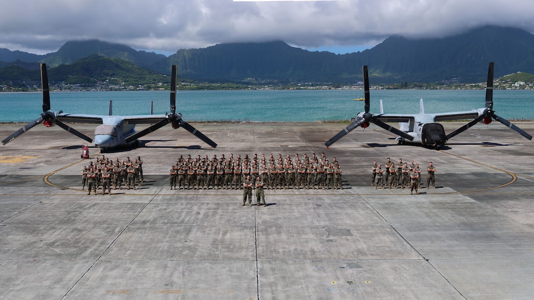 U.S. Marines with Marine Aviation Logistics Squadron 49, 4th Marine Aircraft Wing, Marine Corps Forces Reserve, pose for a group photo after supporting MALS-24, Marine Aircraft Group 24, 1st MAW, during Exercise Rim of the Pacific 2026 at Marine Corps Air Station Kaneohe Bay, Hawaii, July 2, 2026. Thirty nations, over 30 surface ships, five submarines, 15 national land forces, more than 206 aircraft and 30,000 personnel are participating in RIMPAC in and around the Hawaiian Islands, June 24 to July 31. The world's largest international maritime exercise, RIMPAC provides a unique training opportunity while fostering and sustaining cooperative relationships among participants critical to ensuring the safety of sea lanes and security on the world's oceans. RIMPAC 2026 is the 30th exercise in the series that began in 1971. (U.S. Marine Corps photo illustration by Cpl. Anabelle Reed-O’Brien)