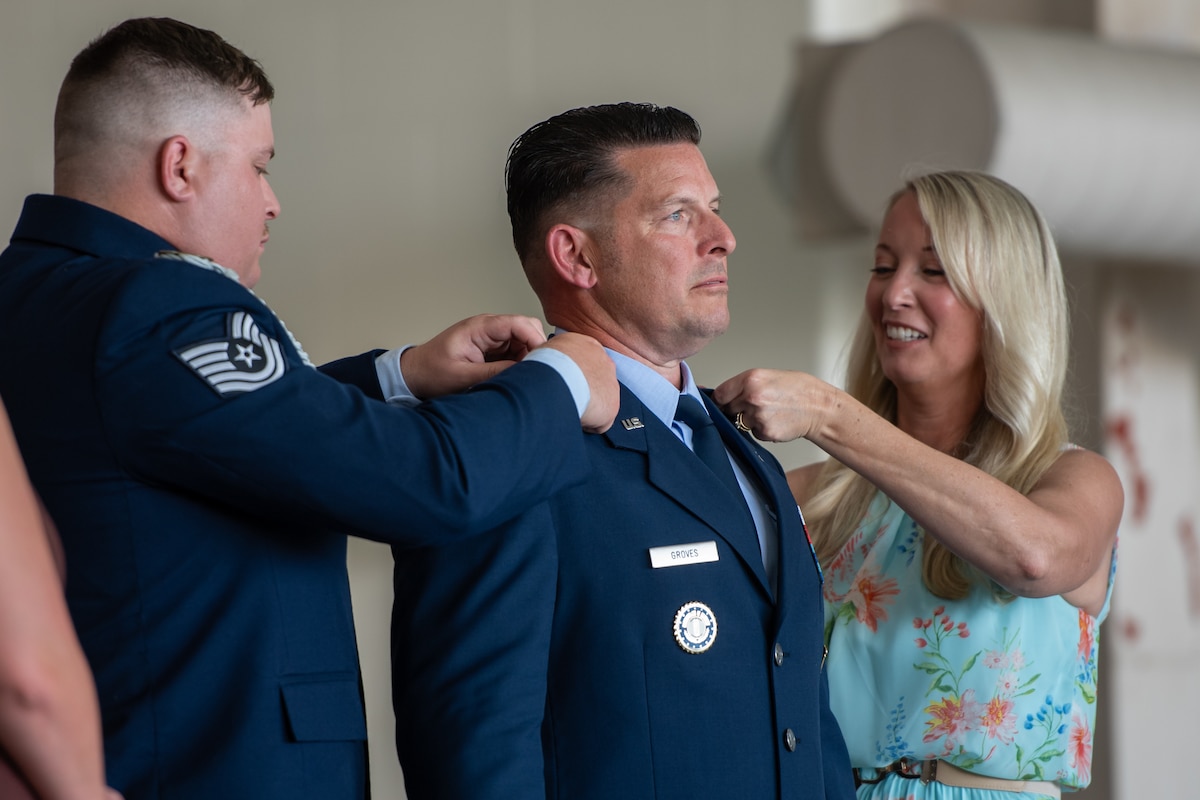 Col. Ash Groves, center, chief of the Air staff at Joint Force Headquarters-Kentucky, is pinned with the rank of brigadier general by family members during a promotion ceremony at the Kentucky Air National Guard Base in Louisville, Ky., June 7, 2026. Groves previously served as headquarters’ director of Air staff. (U.S. Air National Guard photo by Tech. Sgt. Chloe Ochs)