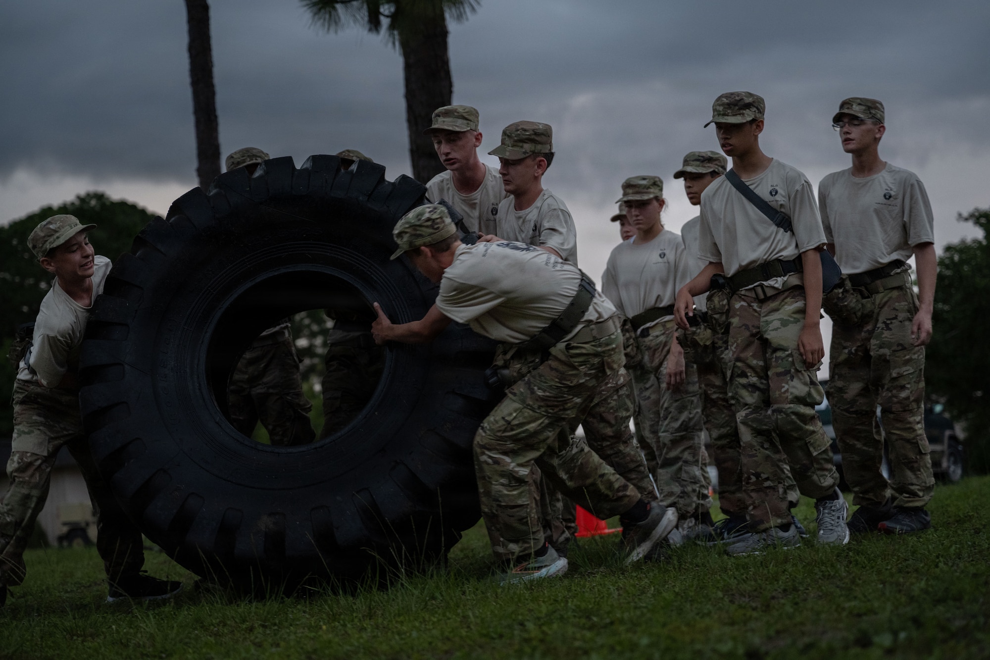 Junior ROTC cadets flip a tire for a Monster Mash team fitness event during Summer Leadership School at Hurlburt Field, Florida, June 26, 2026.