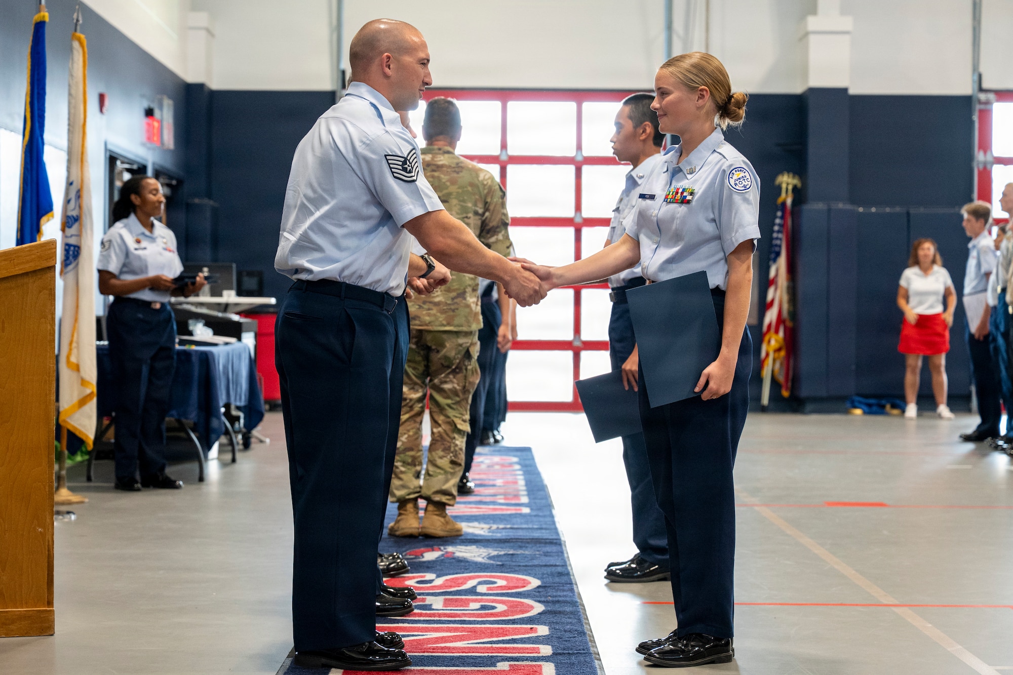 A Junior ROTC cadet receives her certificate of completion during a Summer Leadership School graduation ceremony at Fort Walton Beach High School, Florida, June 26, 2026.