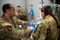Sgt. 1st Class Jose Morales, left, and Sgt. Stephannie LaCasse, both flight medics with the Massachusetts National Guard Detachment 1, C Company, 3rd Battalion, 126th Aviation Regiment, General Support Aviation Battalion, use an artificial manual breathing unit on a medical simulation mannequin in the Boston MedFlight simulation training center at their Bedford, Massachusetts headquarters, July 17, 2026.