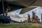 U.S. Air Force students, participating in the Aeromedical Evacuation Patient Staging Course with the 937th Training Squadron, loading a simulated patient onto a C-130 Hercules airframe at Joint Base San Antonio-Camp Bullis, Texas, June 22, 2026. The training teaches Air Force medical personnel how to safely prepare, secure, and transport patients aboard military aircraft during contingency and deployment operations. (U.S. Air Force photo by Melissa Hydrick)