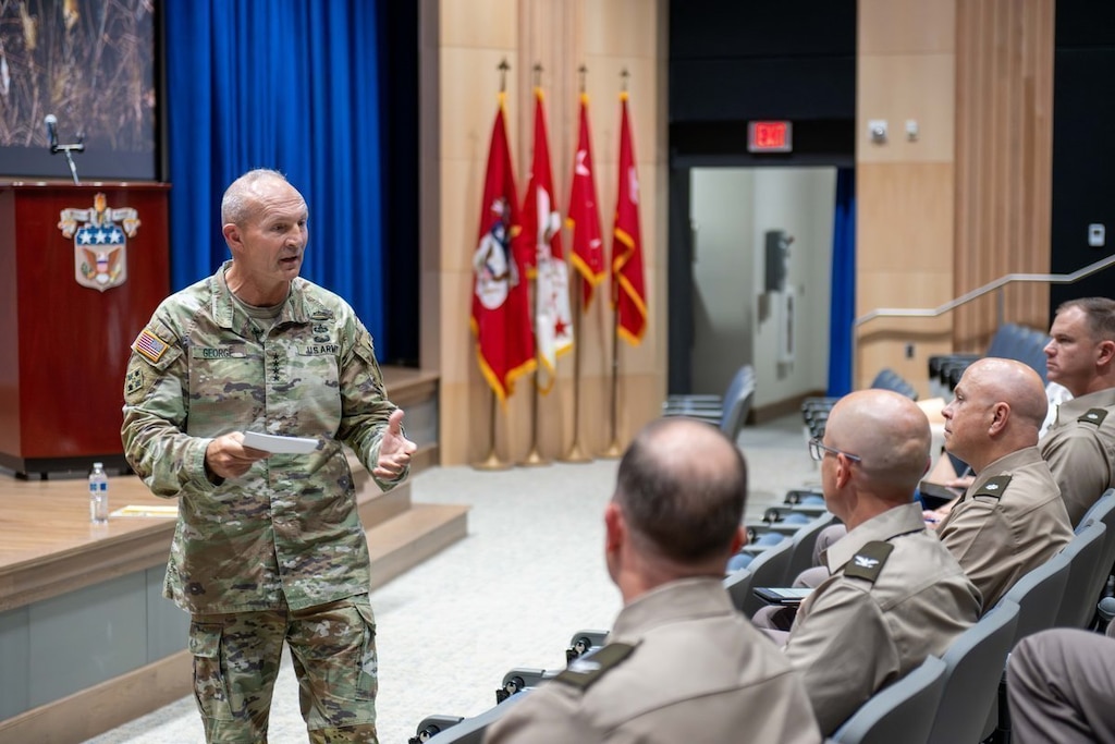 General Randy George addresses a seated audience of military students from the stage of Bliss Auditorium."