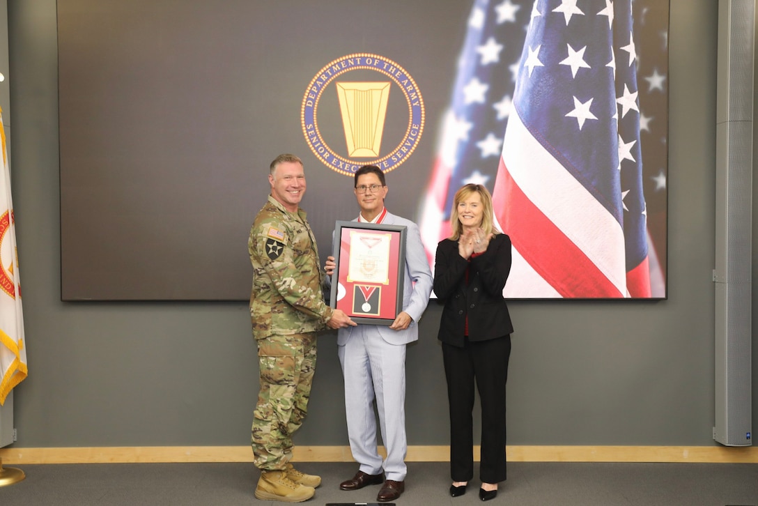 ERDC Commander Lt. Col. Joshua Haynes (left) and ERDC Director Dr. Beth Fleming (right) pose with ERDC Environmental Laboratory Director Dr. Edmond Russo (middle) at his retirement ceremony