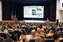 U.S. Air Force Col. John E. Burrell, 5th Bomb Wing commander, addresses members of the 5 BW at an all-call July 23, 2026, at Minot Air Force Base, North Dakota. Burrell also Airmen of current and upcoming wing events, while also answering questions from the audience. (U.S. Air Force photo by Senior Airman Kendra A. Ransum)