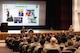 U.S. Air Force Col. John E. Burrell, 5th Bomb Wing commander, addresses members of 5 BW at an all-call July 23, 2026, at Minot Air Force Base, North Dakota. Burrell held the all-call to discuss the wing’s revised Mission, Family and Values lines of effort. (U.S. Air Force photo by Senior Airman Kendra A. Ransum)