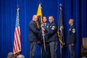 Military members conduct a change of responsibility ceremony