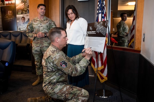 U.S. Space Force Colonel Eric Bogue, Space Base Delta 41 commander, signs the SBD 41 Environmental commitment statement as U.S Air Force Lt Col. Brandon Goebel, 50th Civil Engineer Squadron commander and Jessica Woo, 50 CES environmental chief look on.